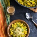 poha sprinkled with sev in a brown bowl served with tea