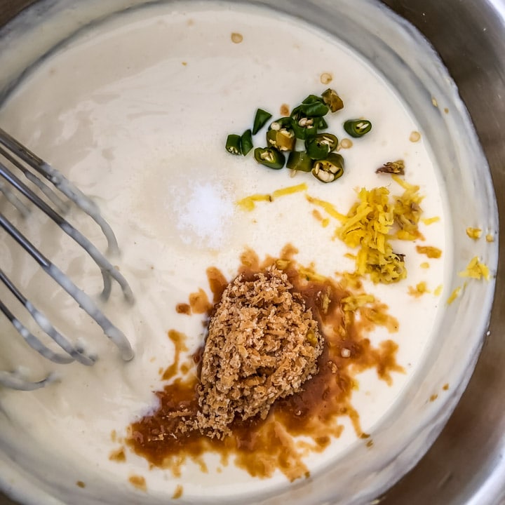 Powdered jaggery, grated ginger, chopped green chilies added to besan-yogurt mixture