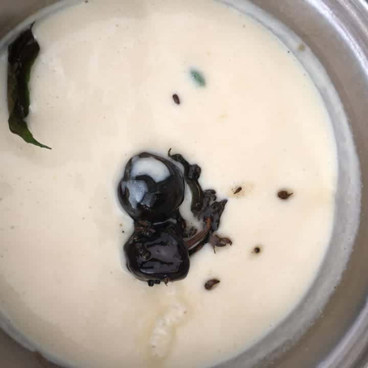 Add the tempering to the boiled besan-yogurt mixture.