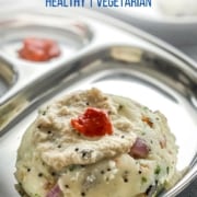 Rava upma served in a steel plate along with cooconut chutney and pickle