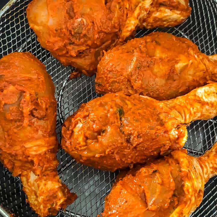 Place the marinated chicken on the trivet or the air frying basket