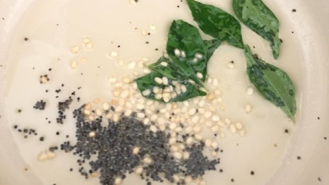 Mustard seeds and curry leaves in oil