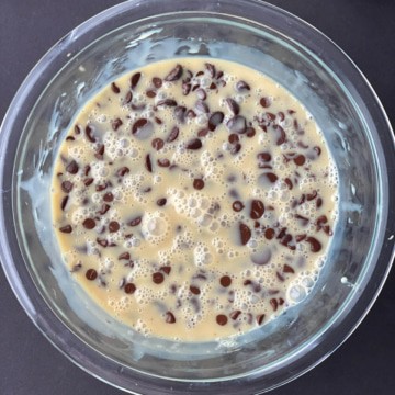 Melted chocolate chips and condensed milk in a glass bowl