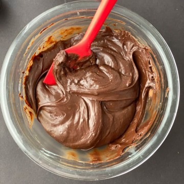 Condensed milk and melted chocolate chips mixture in a glass bowl