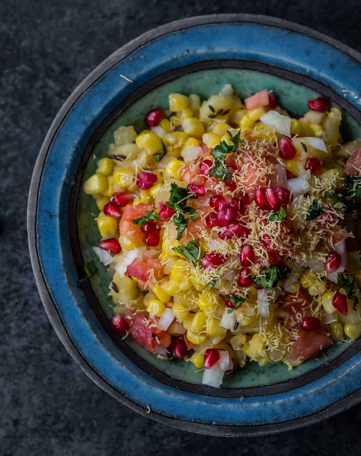 Corn chaat served in a blue bowl
