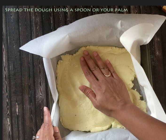 spread the dough using the back of the spoon or your palm