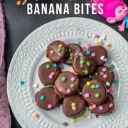 Frozen chocolate covered banana bites served on a white plate