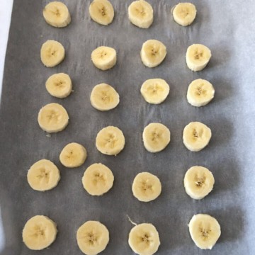 Bite-sized bananas placed on parchment paper