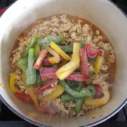 Bell peppers added to the pot of thai basil chicken.