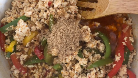 Spices added to the pot of thai basil chicken.