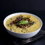Kaale channe ki kadhi served in a white bowl placed over a brown napkin