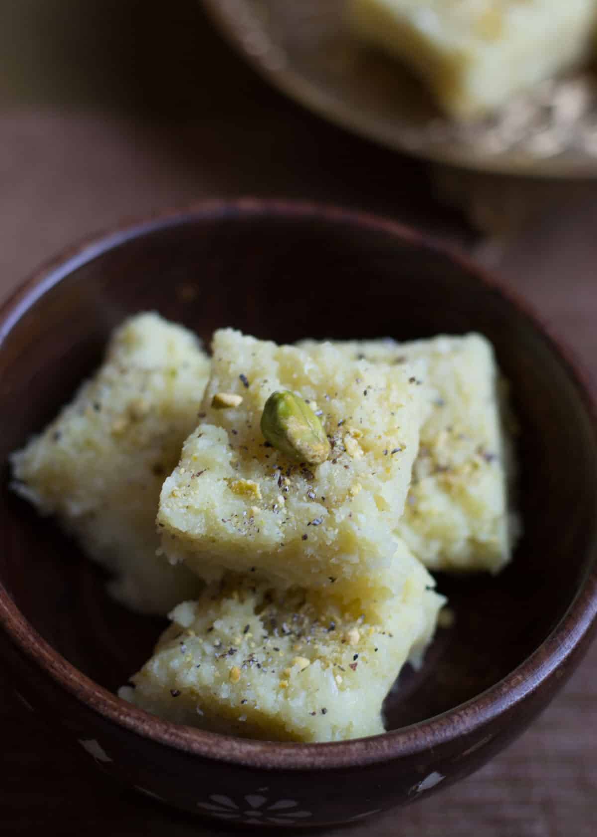 Coconut barfi served in a wooden bowl