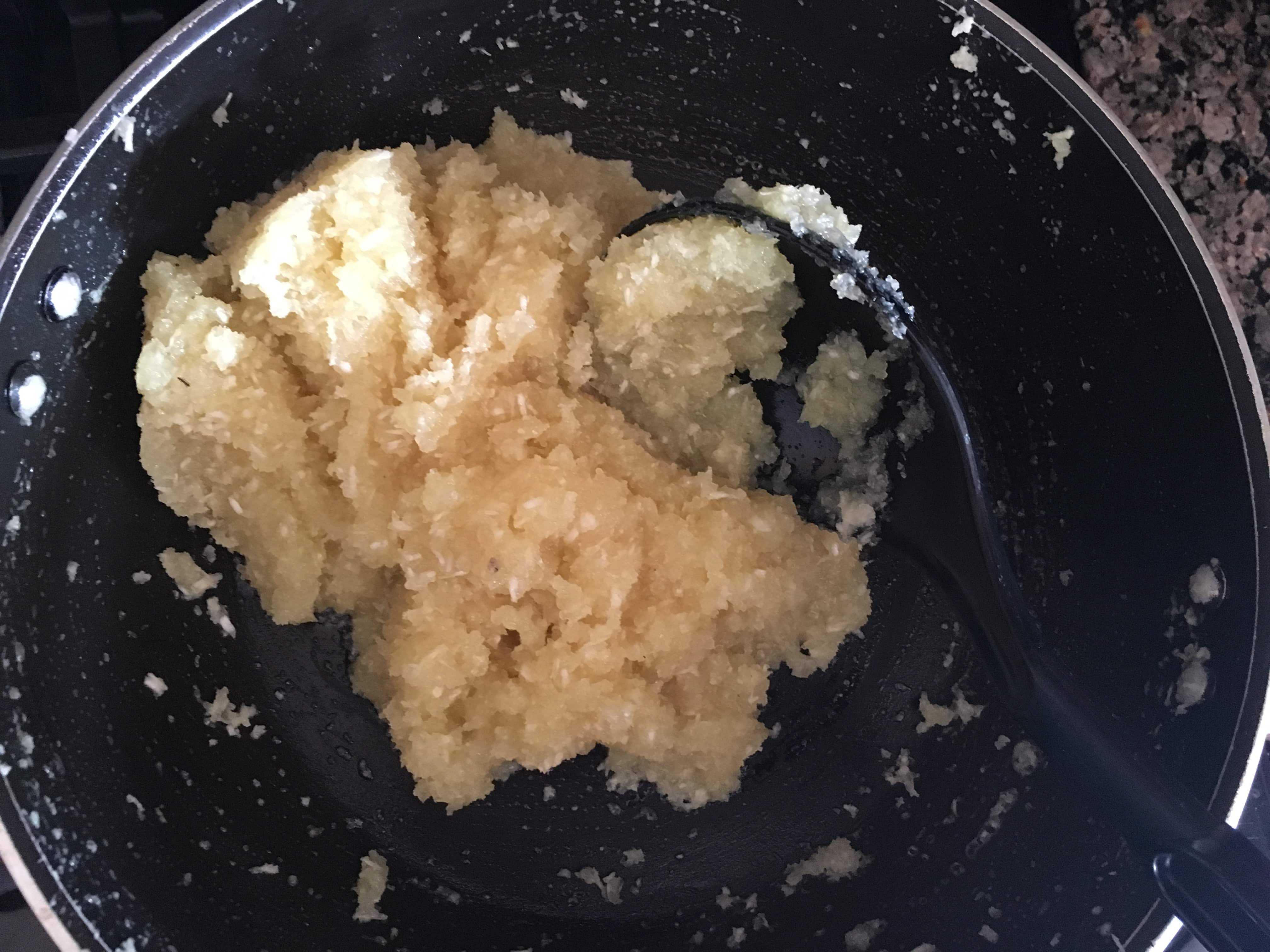 Coconut  barfi mixture in a non-stick pan