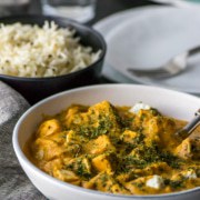 Paneer Makhani served in a white bowl sprinkled with roasted fenugreek leaves