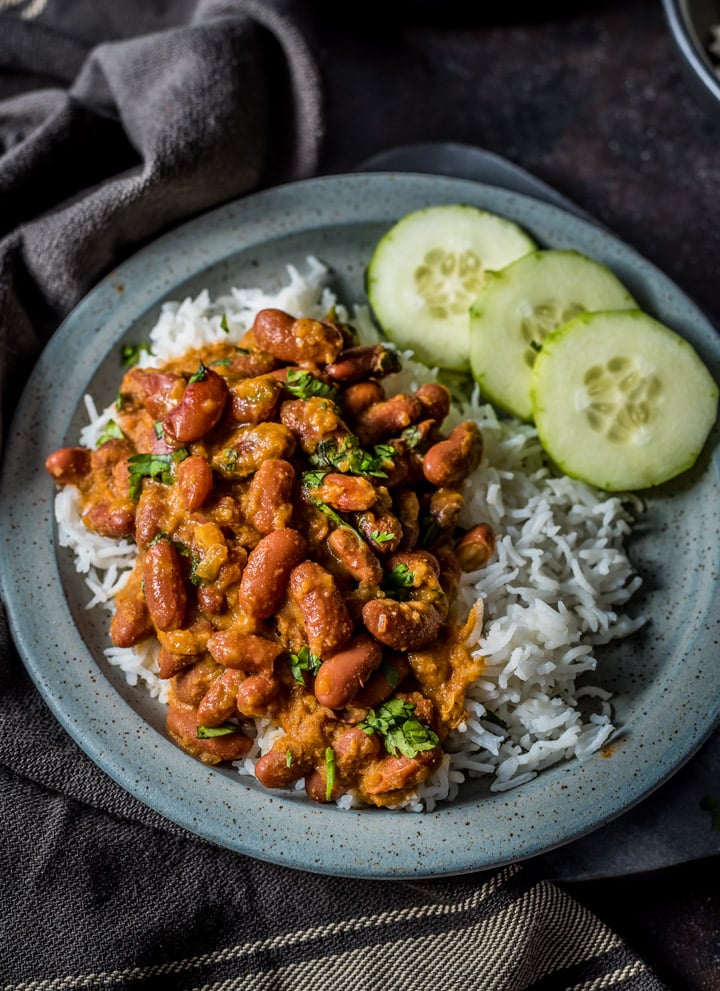 An overhead shot of rajma chawal served on a gray plate.
