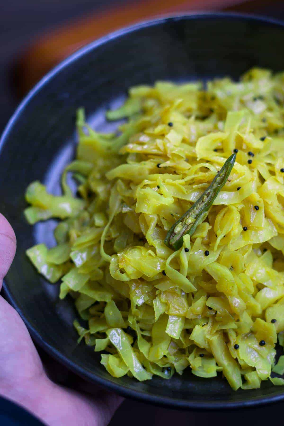 Cabbage sukka or palya Recipe - This simple, yet flavorful stir-fried cabbage preparation pairs well with steamed rice and sambar and makes for a perfect afternoon meal. 