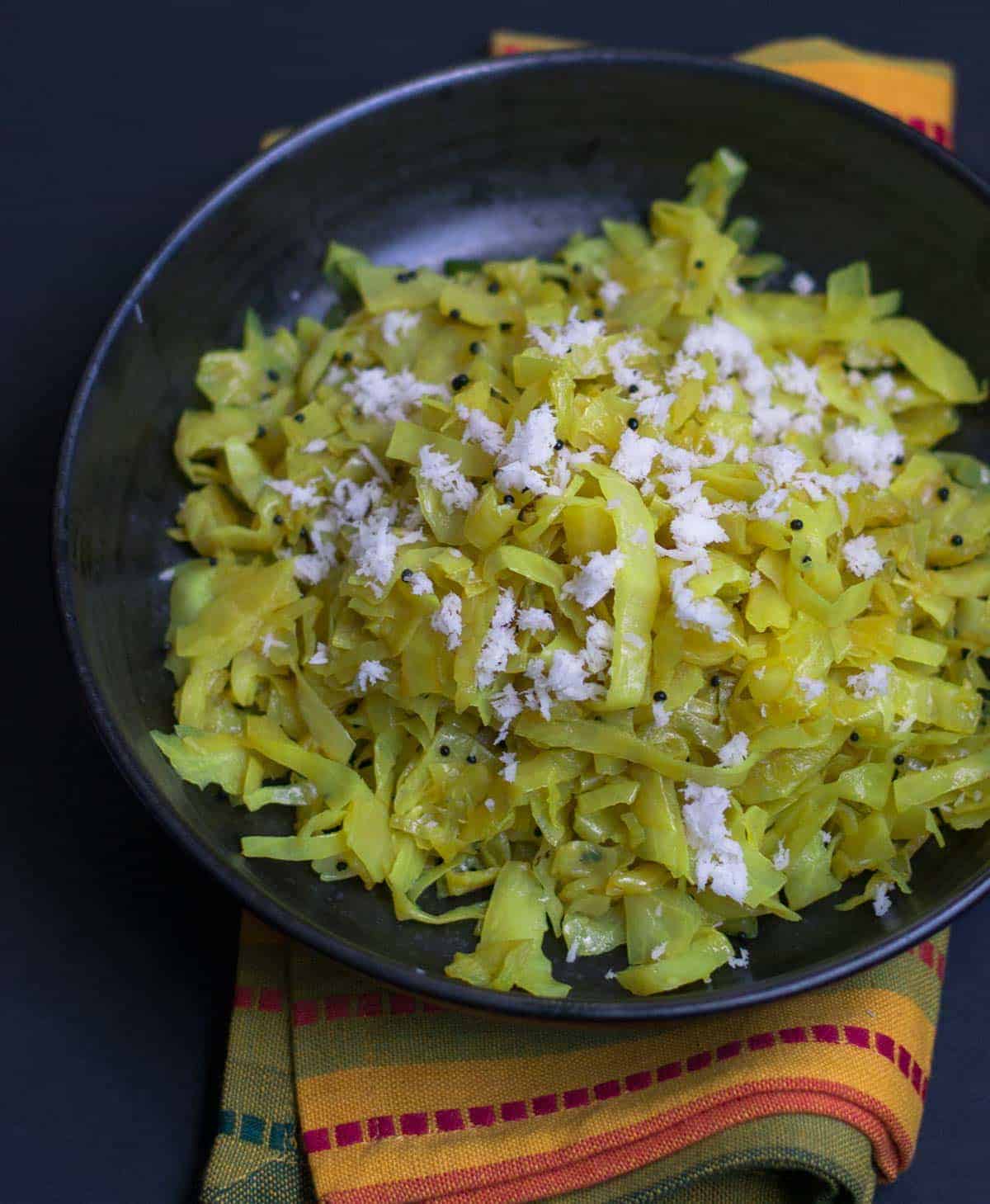 Cabbage Palya or Sukka Recipe - This simple, yet flavorful stir-fried cabbage preparation pairs well with steamed rice and sambar and makes for a perfect afternoon meal. 