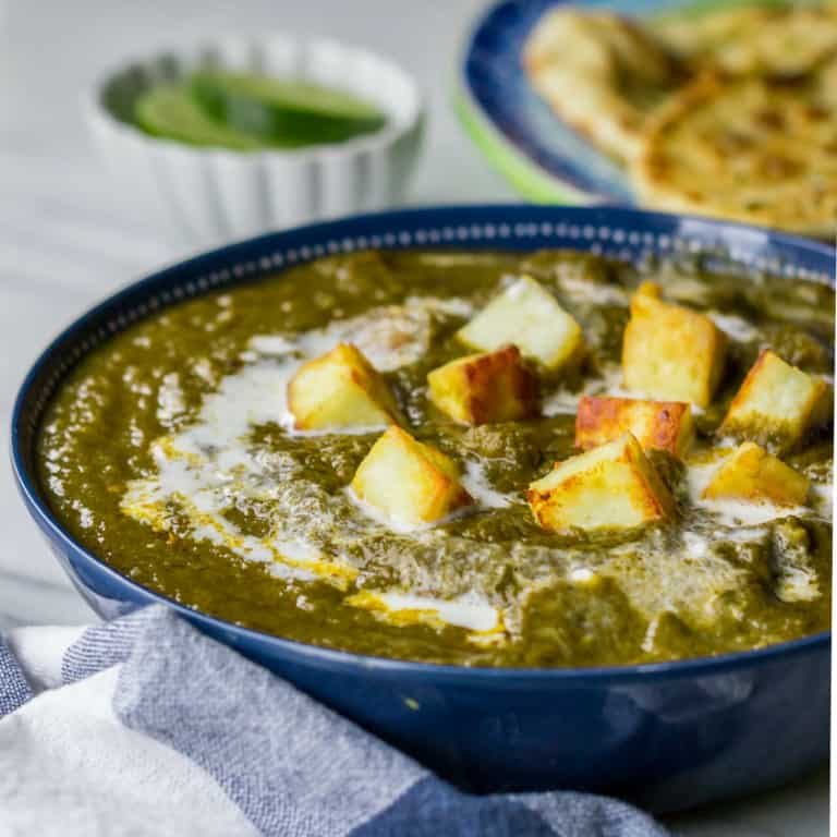Palak paneer served in a blue bowl