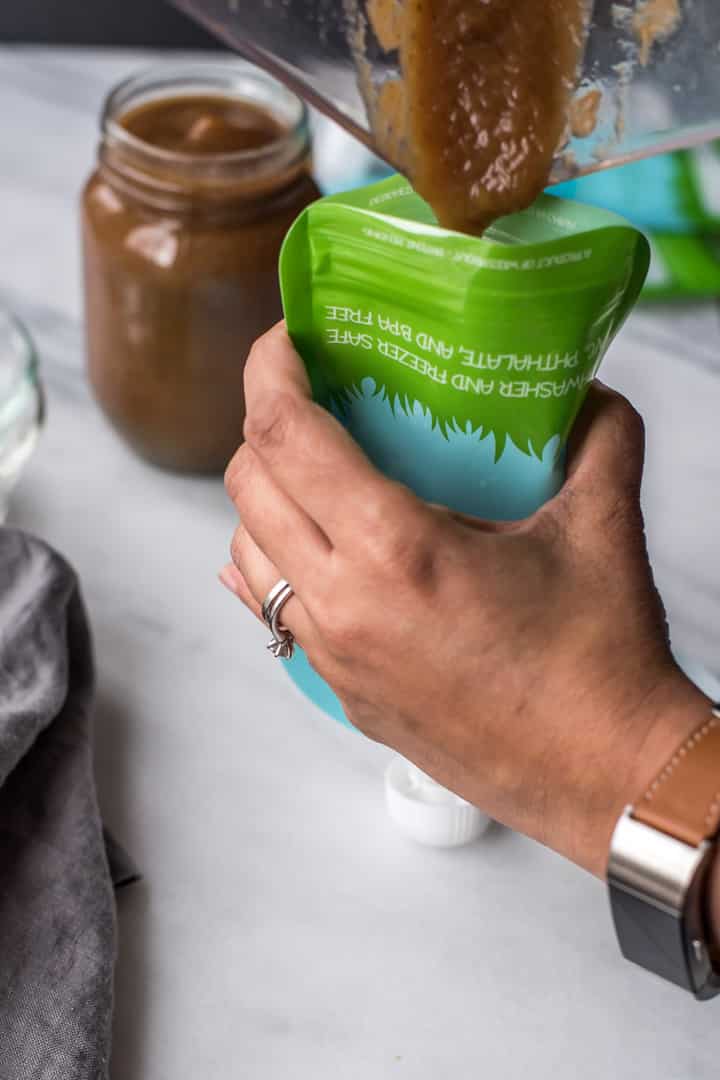 Instant pot applesauce is poured in a reusable pouch.