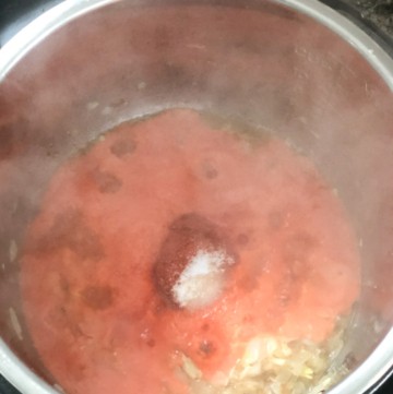 Adding tomato puree to dum aloo gravy