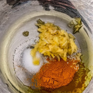 Garlic, turmeric, green chillies, and salt added to hot oil in Instant Pot