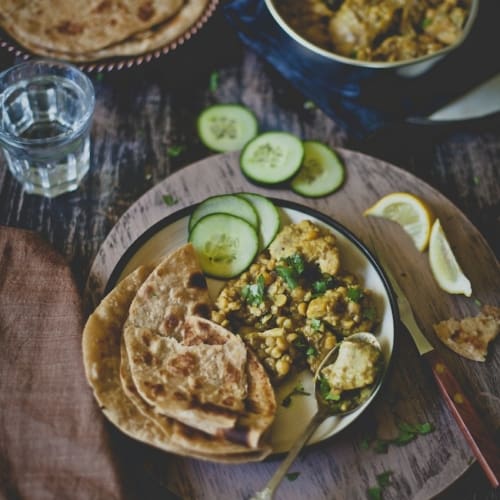 Murgh dhansak served with roti and cucumber slices