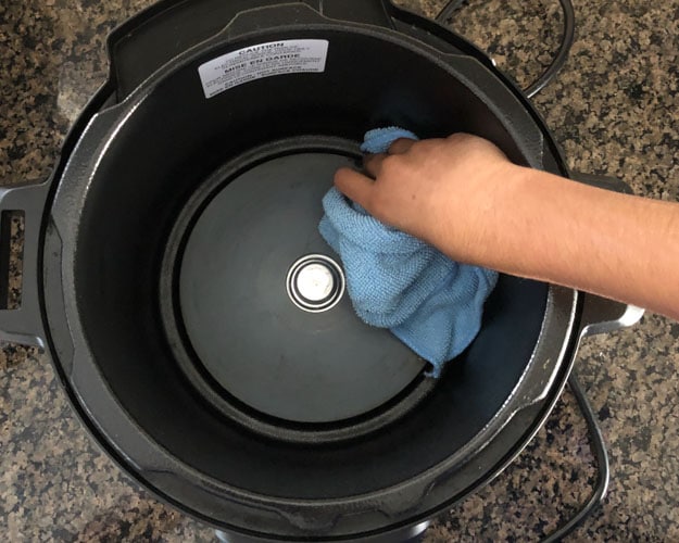 Clean Instant Pot Base with damp cloth