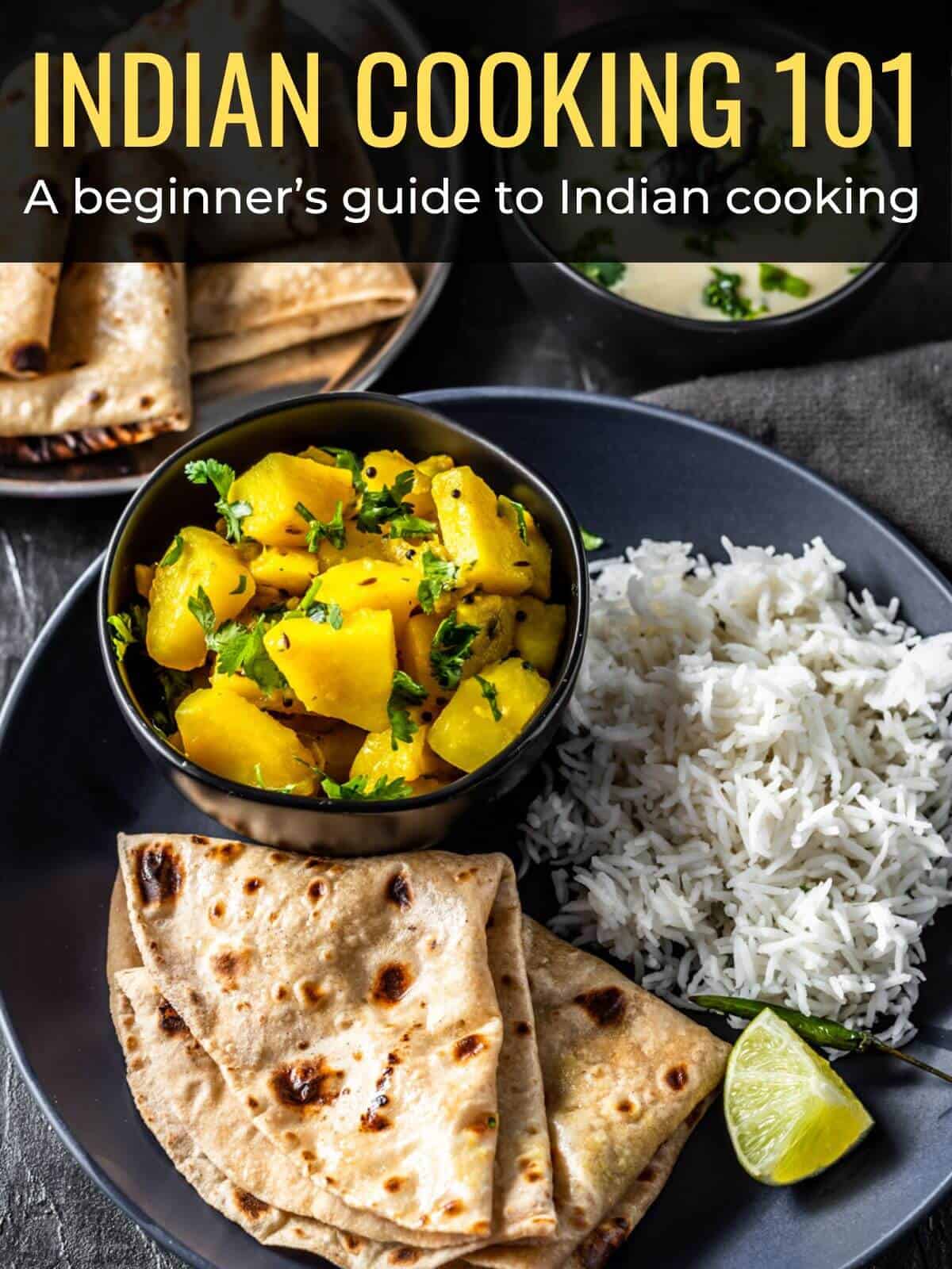 A black plate with rice, lemon wedges and potato side dish. A caption over the image reads Indian cooking basics learn more