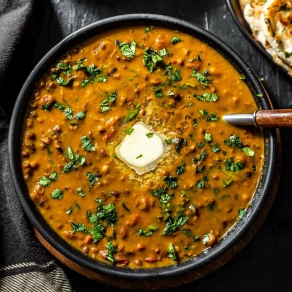 An overhead shot of Dal Makhani in a black bowl