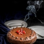 A cakey brownie on a cake stand with a candle blown out and smoke in the air with the words Instant Pot Homemade Brownie Recipe at the top.