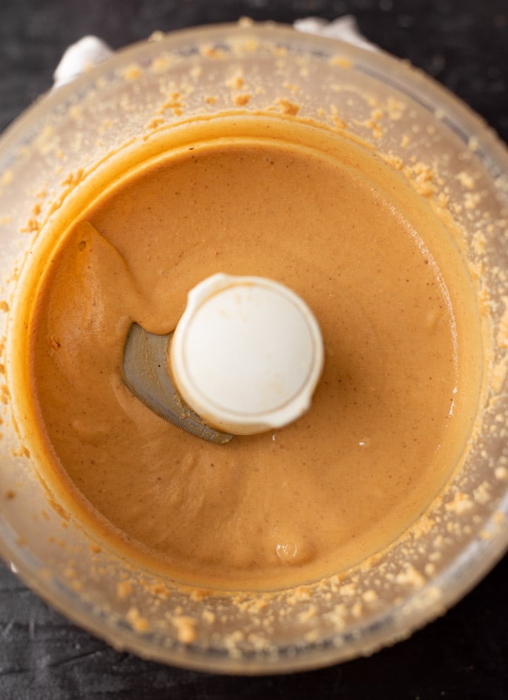 Creamy peanut butter in a food processor with the words.