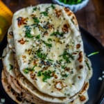 A stack of fresh naan bread.