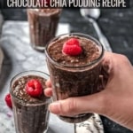 A hand holding a glass of chocolate chia seed pudding