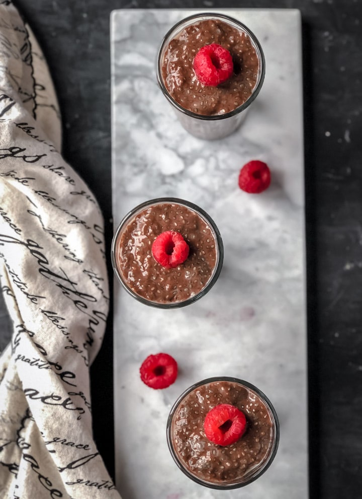 An overhead shot of 3 glasses of chocolate chia pudding 