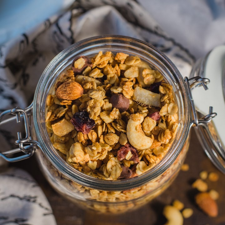 An overhead shot of granola in a glass container