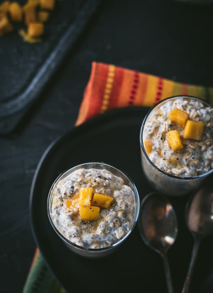An overhead shot of Mango overnight oats served in glasses
