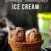 A waffle bowl with scoops of double chocolate ice cream on a wooden counter with the words Double Chocolate Ice Cream at the top.