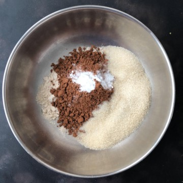 A mixing bowl with the dry ingredients for moist chocolate zucchini bread.