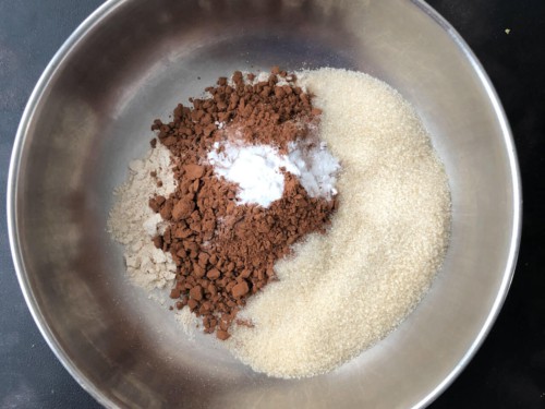 A mixing bowl with the dry ingredients for moist chocolate zucchini bread.