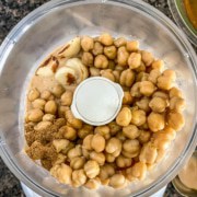 Ingredients for instant pot hummus in the base of a food processor.