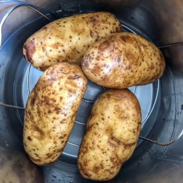 Four potatoes in an instant pot before cooking.