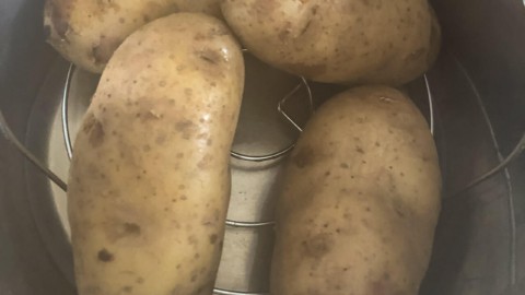 Four potatoes in an instant pot after cooking.
