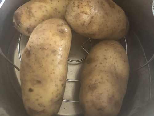 Four potatoes in an instant pot after cooking.