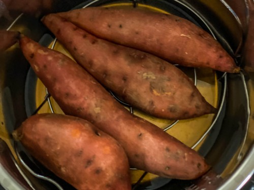 4 sweet potatoes in an instant pot on a trivet.