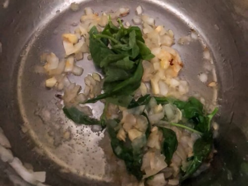 Garlic, onion, and basil in the base of the instant pot.