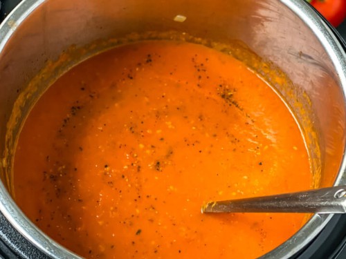 Blended marinara sauce with a spoon in the instant pot.