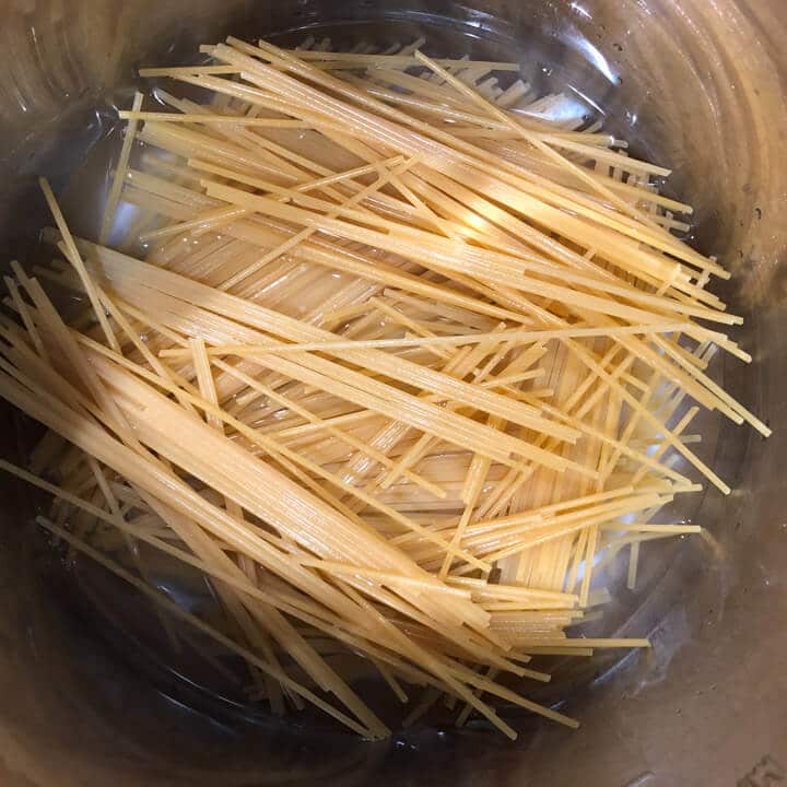 Water on top of the pasta noodles in the instant pot before cooking.