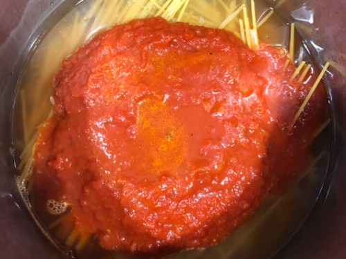 Marinara sauce on top of the water and pasta in the instant pot before cooking.