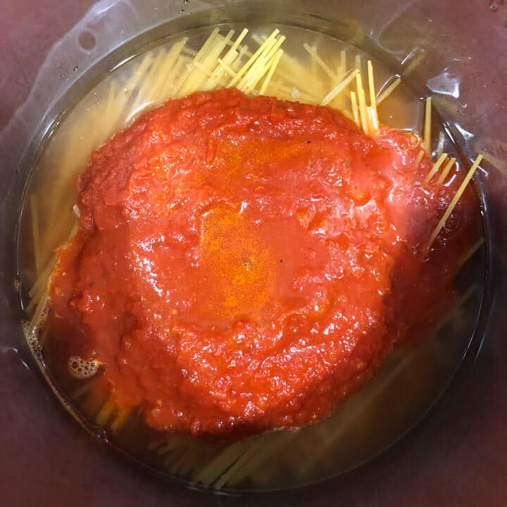 Marinara sauce on top of the water and pasta in the instant pot before cooking.