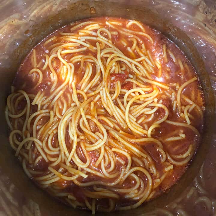 Cooked pasta and sauce in the instant pot after cooking and stirring.